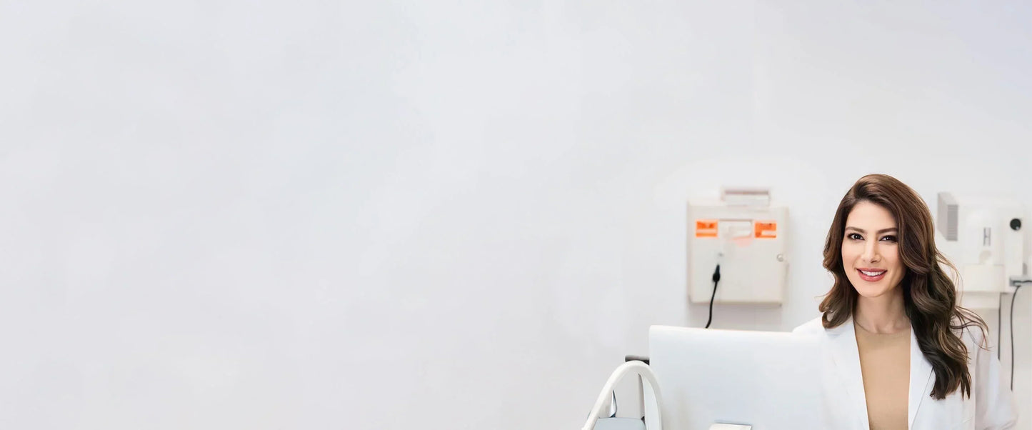 Smiling female medical professional in white coat at LaxeHaven clinic with modern equipment